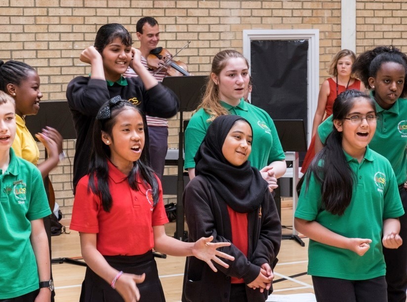 Secondary school pupils singing at a workshop
