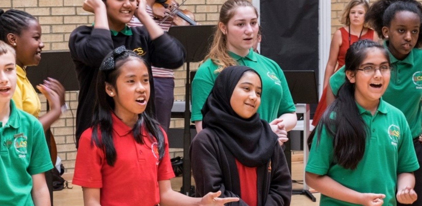 Secondary school pupils singing at a workshop