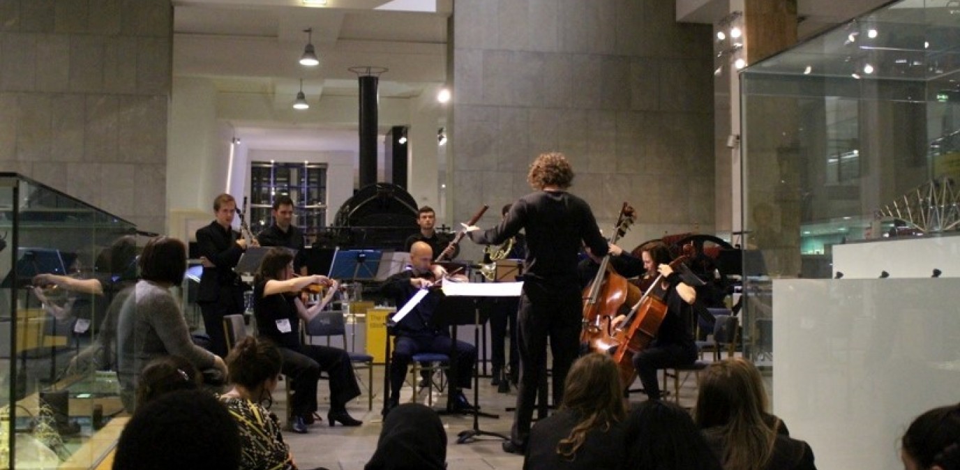A group of musicians performs for primary school students