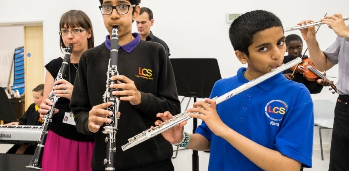 Secondary school pupils playing clarinets and flutes